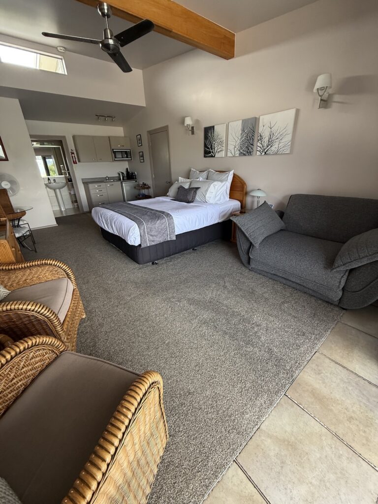 Pool View Bedroom with queen bed and comfortable sofa chair that converts to a bed