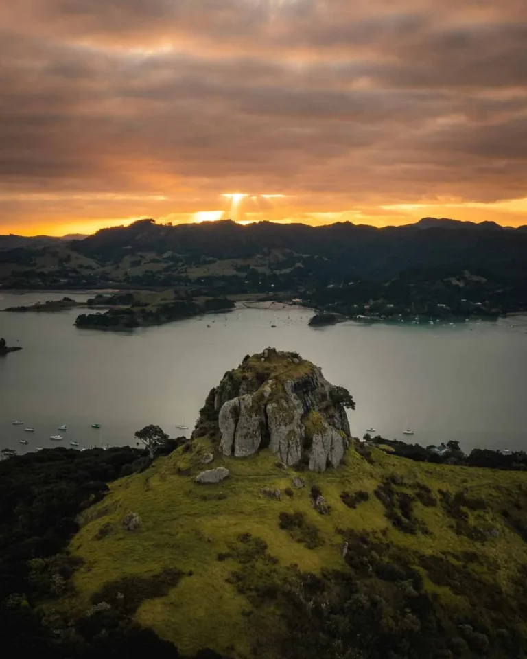 Aerial drone photo of St. Paul's rock with Whangaroa Harbour in background at sunset near King's View Lodge